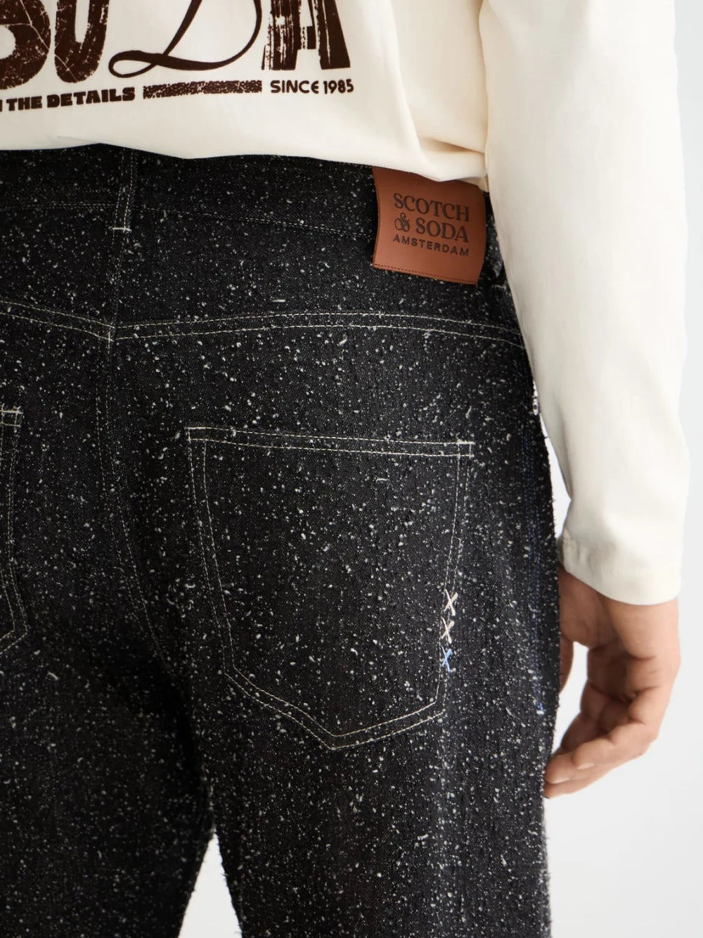The Pitch Loose Jeans — Black Snow detail shot of fabric and craftsmanship by Scotch & Soda