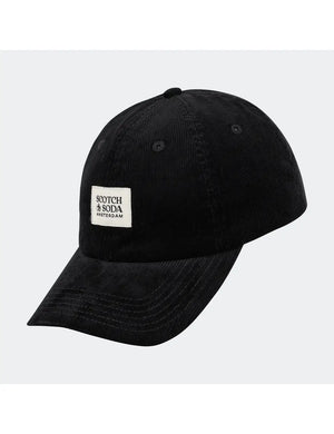 Black cap with a white label on a light gray background