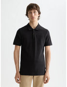 Logo Pique Polo close-up on model showing fit and detail by Scotch & Soda