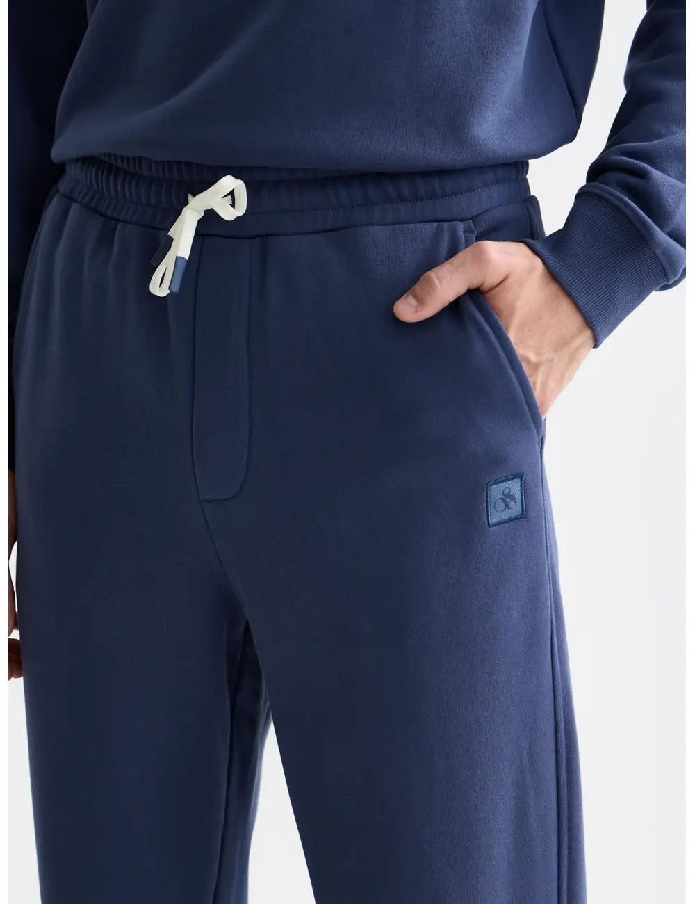 Seasonal Core Logo Badge Regular-fit Sweatpants detail shot of fabric and craftsmanship by Scotch & Soda