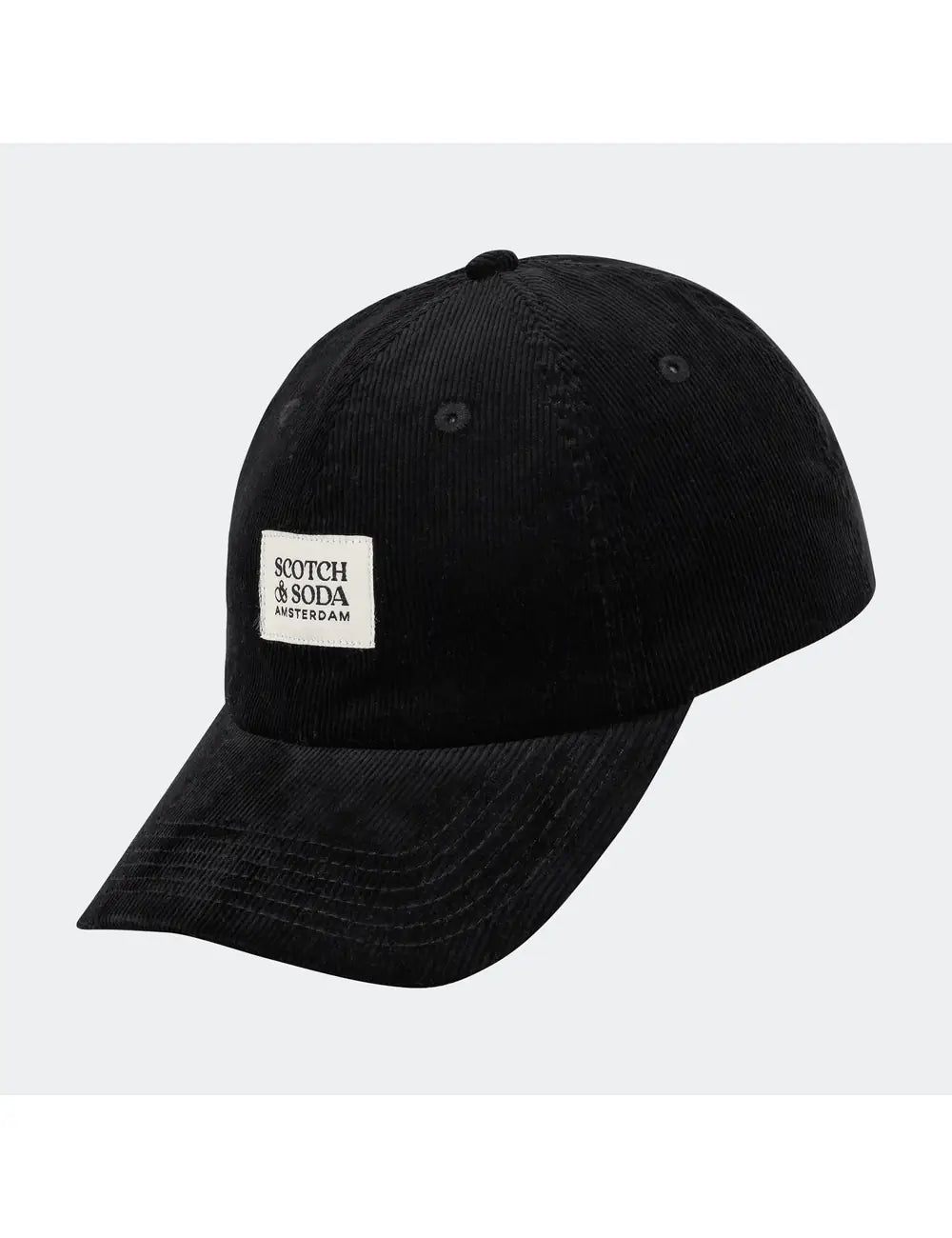 Black cap with a white label on a light gray background